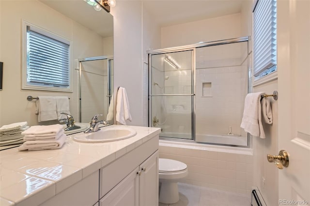 bathroom featuring tiled shower / bath, toilet, plenty of natural light, and tile patterned floors
