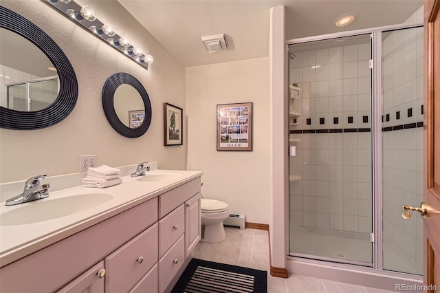 full bath featuring baseboard heating, a stall shower, toilet, and double vanity