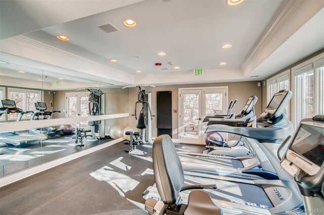 exercise room featuring french doors, healthy amount of natural light, a tray ceiling, recessed lighting, and ornamental molding