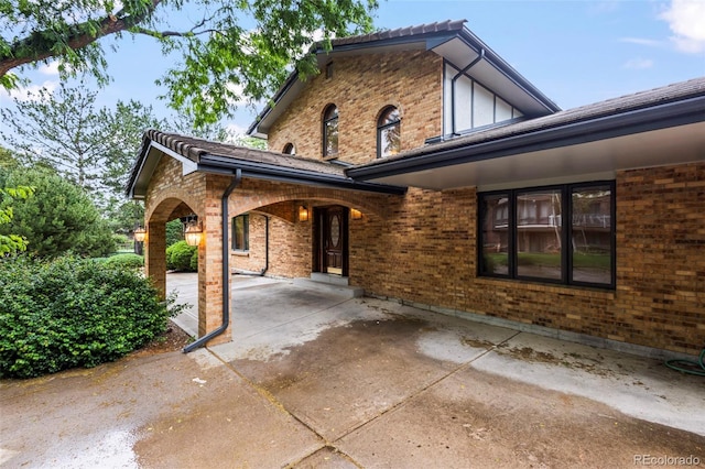 7351 Poppy Way, Arvada, CO 80007 - view of property exterior with brick siding and a patio