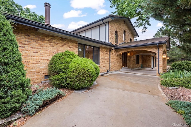 7351 Poppy Way, Arvada, CO 80007 - view of front of property featuring brick siding, covered porch, and board and batten siding