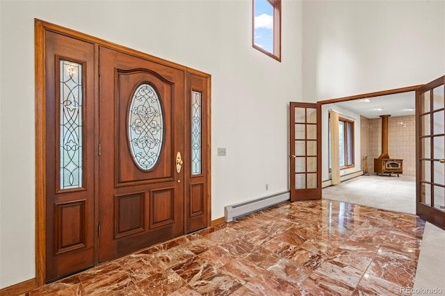 7351 Poppy Way, Arvada, CO 80007 - foyer entrance with a baseboard radiator, french doors, a high ceiling, marble finish floors, and a wood stove