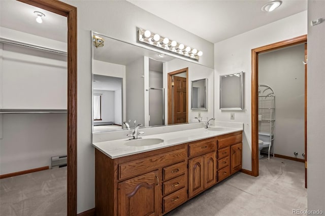 7351 Poppy Way, Arvada, CO 80007 - bathroom featuring double vanity and baseboard heating