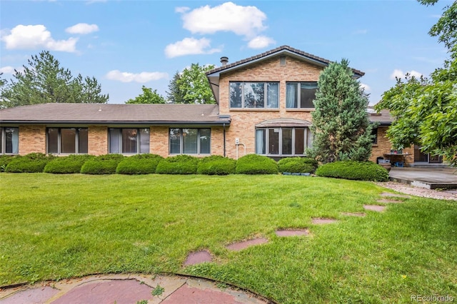 7351 Poppy Way, Arvada, CO 80007 - view of front of home featuring brick siding and a front lawn