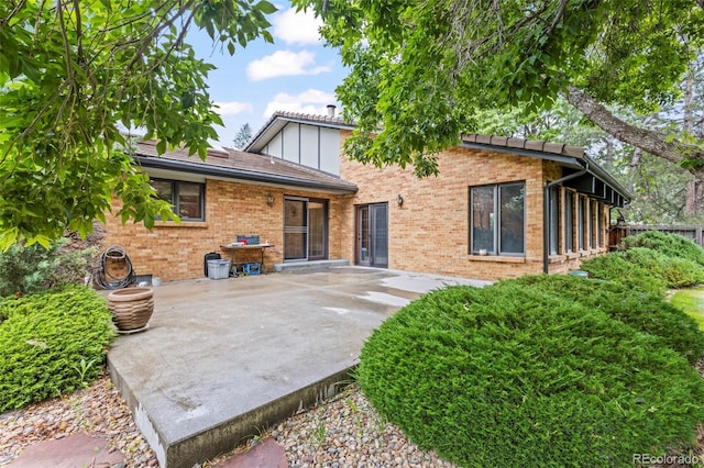 7351 Poppy Way, Arvada, CO 80007 - rear view of house with a patio area and brick siding