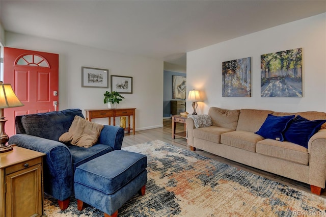 living room featuring baseboards and light wood-style floors
