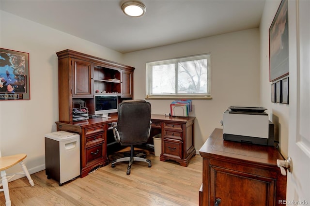 home office with light wood-style flooring