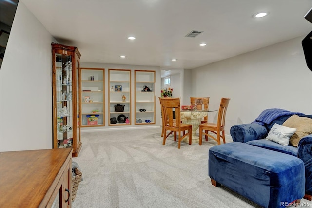 sitting room with light colored carpet, recessed lighting, and visible vents