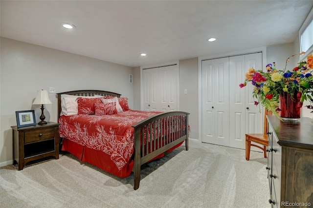 bedroom featuring two closets, recessed lighting, baseboards, and carpet