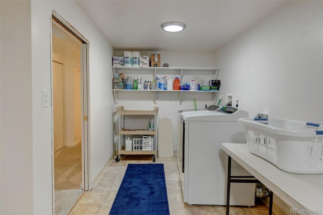 laundry room with laundry area, a sink, and washing machine and dryer