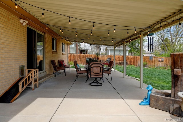 view of patio featuring a fenced backyard and outdoor dining space