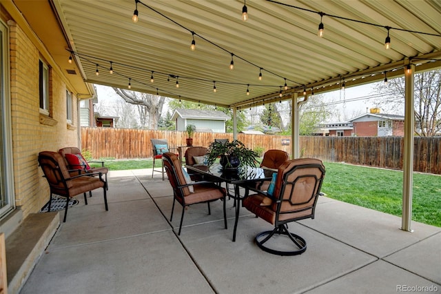 view of patio with a fenced backyard and outdoor dining area