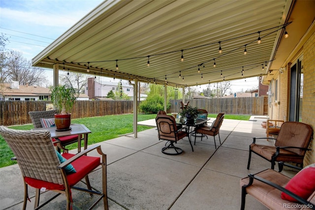 view of patio featuring outdoor dining space and a fenced backyard