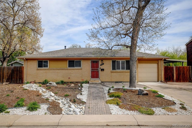 ranch-style home featuring fence, concrete driveway, a garage, and brick siding