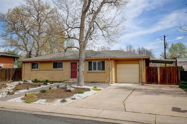 single story home featuring brick siding, a garage, fence, and driveway