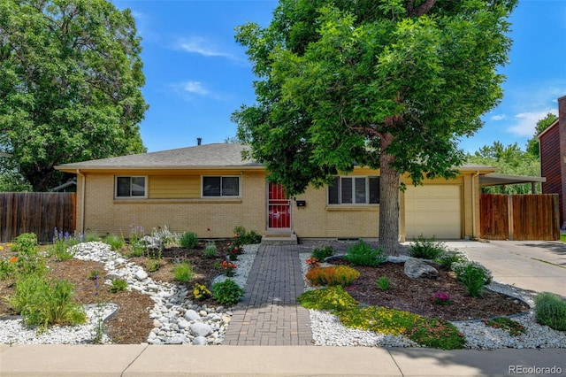 6020 Quail St, Arvada, CO 80004 - single story home featuring brick siding, concrete driveway, and a garage