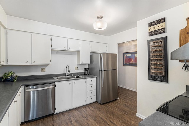 7250 Eastmoor Dr Unit 203, Denver, CO 80237 - kitchen featuring appliances with stainless steel finishes, dark countertops, dark wood-style flooring, and white cabinetry