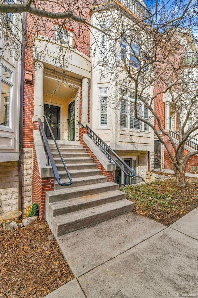 entrance to property featuring brick siding