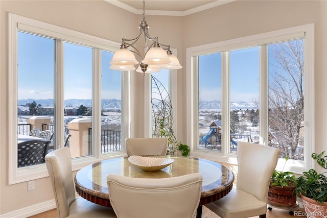 dining space featuring a chandelier, crown molding, and a mountain view