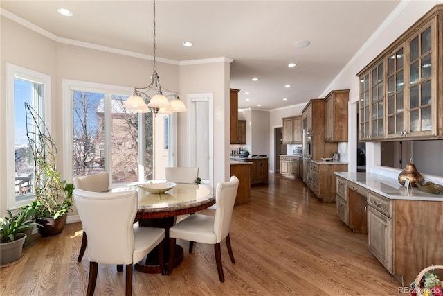 dining space featuring crown molding and hardwood / wood-style flooring