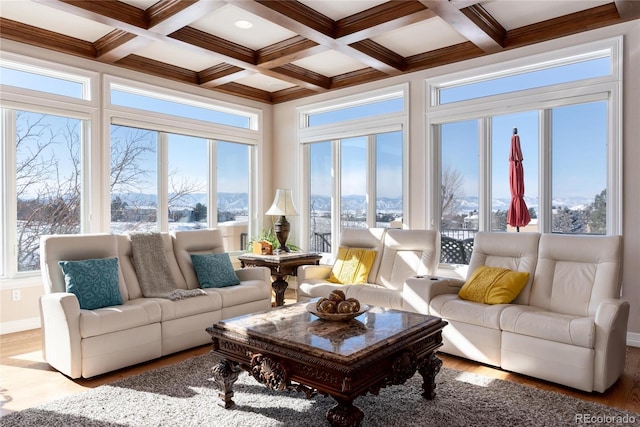 sunroom featuring a mountain view, coffered ceiling, and beam ceiling