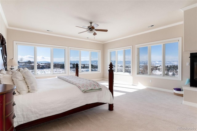 carpeted bedroom featuring crown molding and ceiling fan