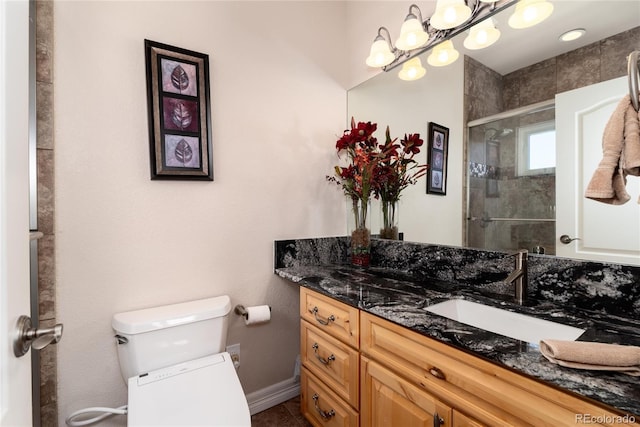 bathroom with vanity, toilet, and walk in shower