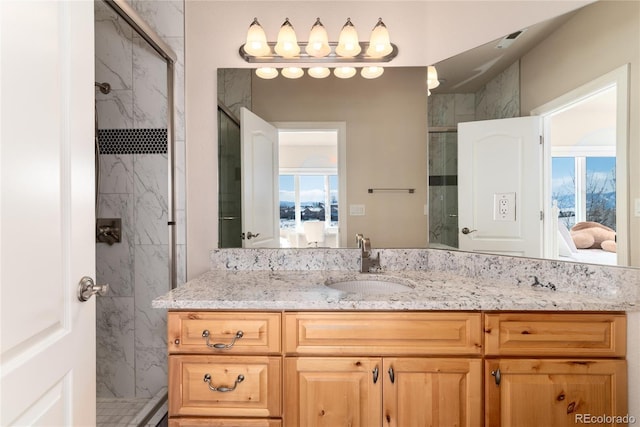 bathroom with vanity and a shower with shower door