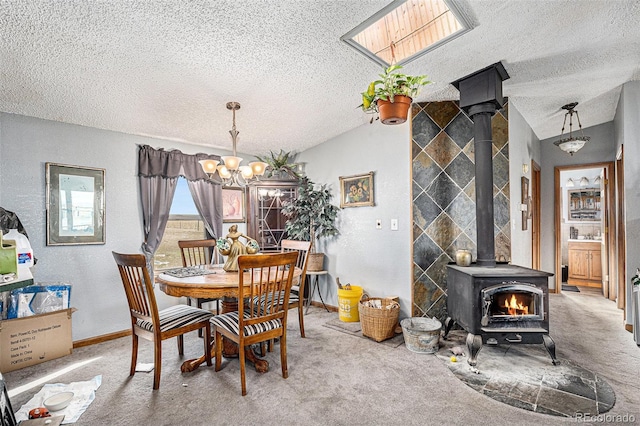 carpeted dining space featuring a textured ceiling, vaulted ceiling, a chandelier, and a wood stove