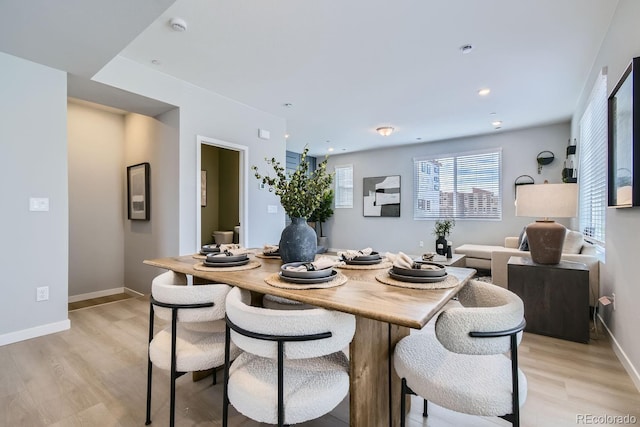 dining space with light wood-type flooring