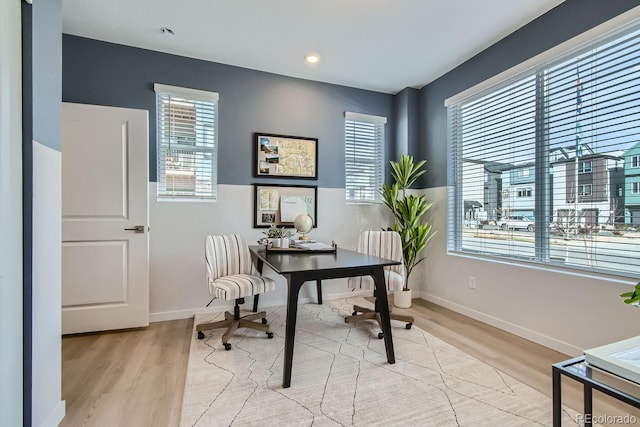 office space featuring a wealth of natural light and light hardwood / wood-style flooring