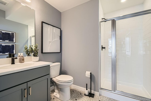 bathroom featuring a shower with door, toilet, tile patterned flooring, and vanity