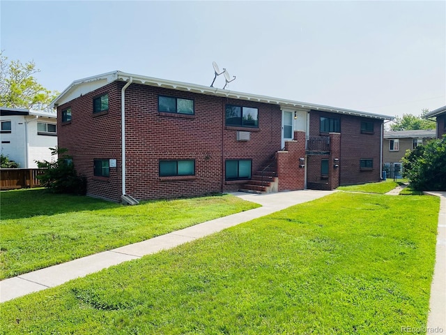 3728 N Vance St Unit 1-4, Wheat Ridge, CO 80033 - rear view of house with a yard and brick siding