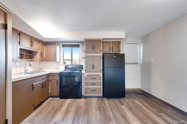 3728 N Vance St Unit 1-4, Wheat Ridge, CO 80033 - kitchen with black appliances, a sink, light wood finished floors, open shelves, and light countertops