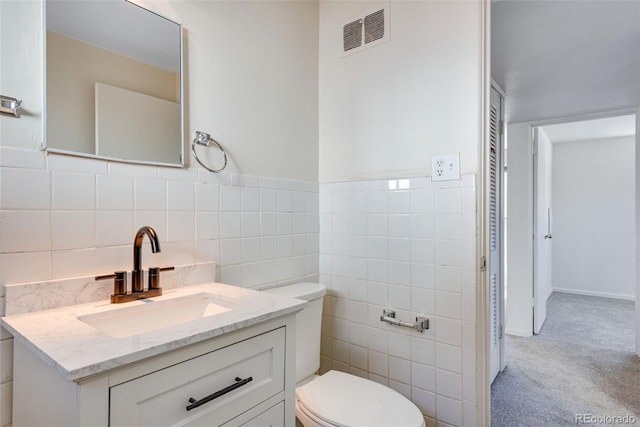 3728 N Vance St Unit 1-4, Wheat Ridge, CO 80033 - bathroom featuring toilet, tile walls, and vanity