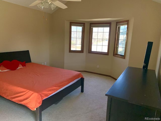 carpeted bedroom featuring a ceiling fan, vaulted ceiling, and baseboards