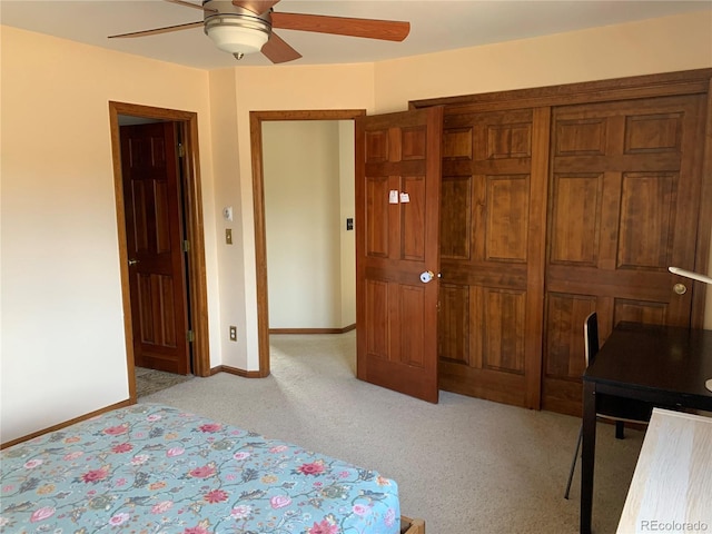 bedroom featuring light carpet, baseboards, and a ceiling fan