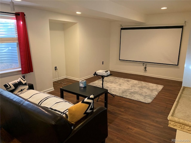 home theater room with dark wood-type flooring, recessed lighting, and baseboards