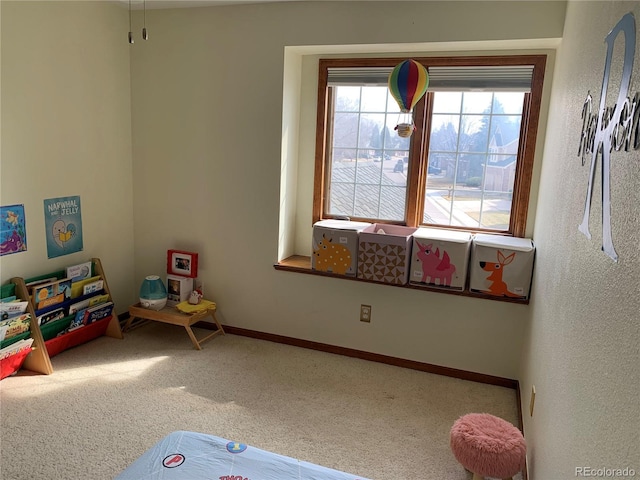 game room with baseboards and carpet flooring