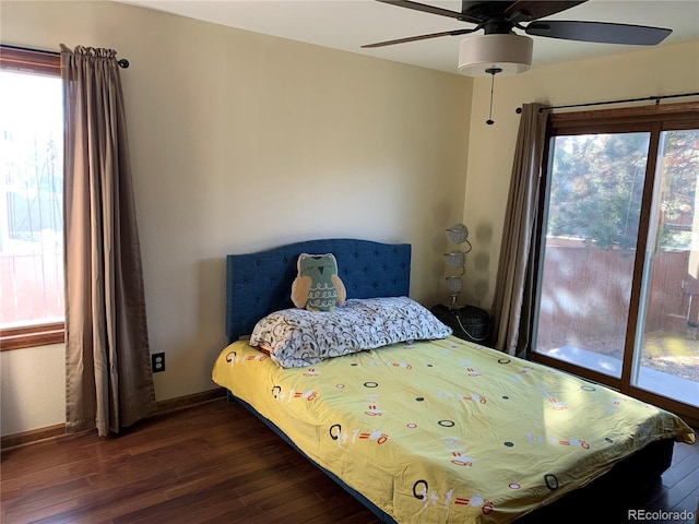 bedroom with ceiling fan, multiple windows, hardwood / wood-style flooring, and baseboards