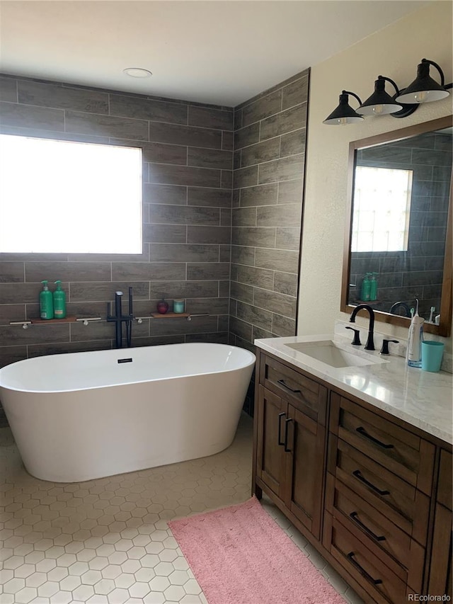 full bath with a soaking tub and vanity