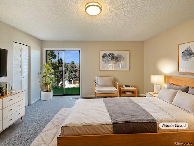 bedroom with access to exterior, a closet, light colored carpet, and a textured ceiling