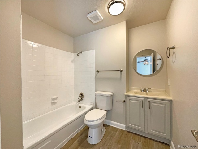 full bathroom featuring toilet, hardwood / wood-style floors, vanity, and bathing tub / shower combination