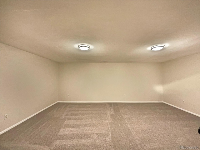 spare room featuring carpet and a textured ceiling