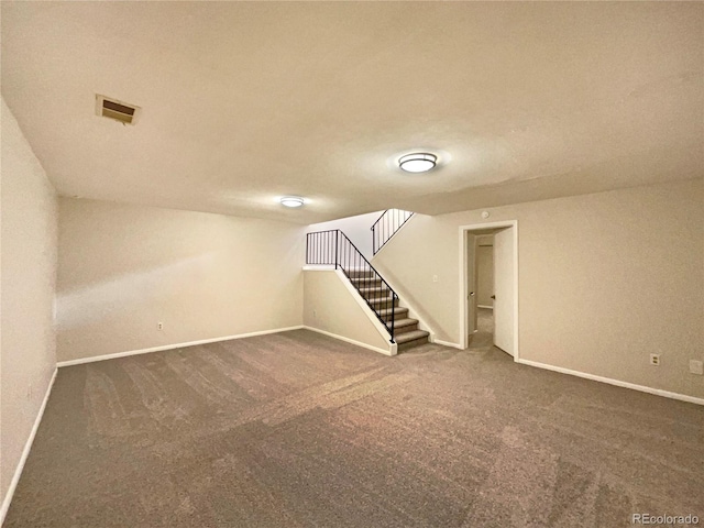 basement featuring dark carpet