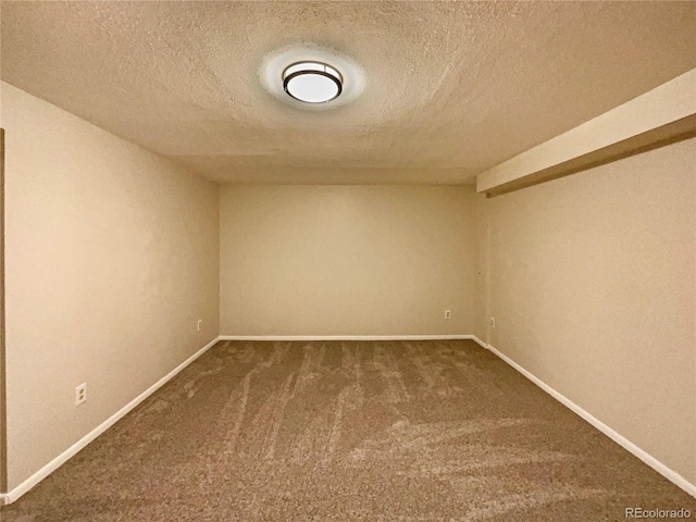 spare room with carpet flooring and a textured ceiling