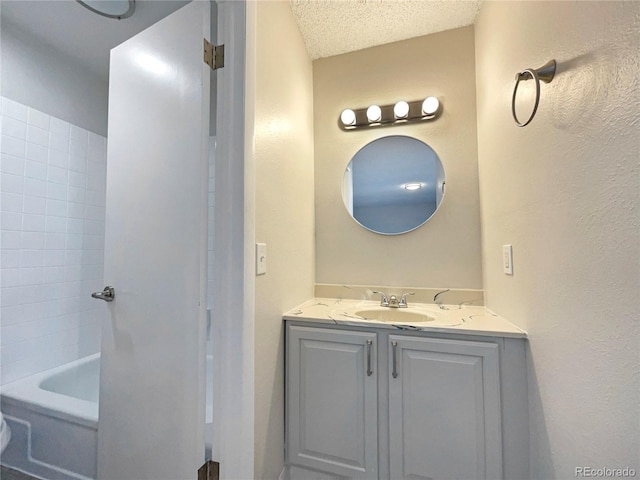 bathroom with vanity and a textured ceiling