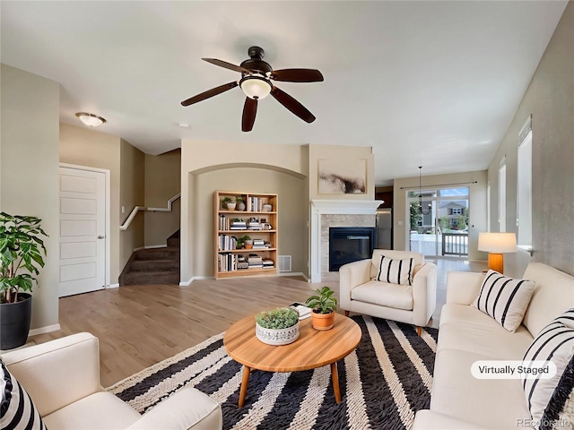 2258 Whistler Dr, Longmont, CO 80504 - living room with ceiling fan, a glass covered fireplace, stairs, wood finished floors, and baseboards
