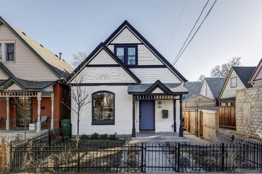 182 W Bayaud Ave, Denver, CO 80223 - view of front of property with stucco siding and a fenced front yard