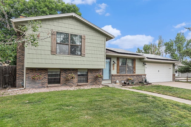 309 S 30th Ave, Brighton, CO 80601 - tri-level home with roof mounted solar panels, brick siding, an attached garage, and concrete driveway